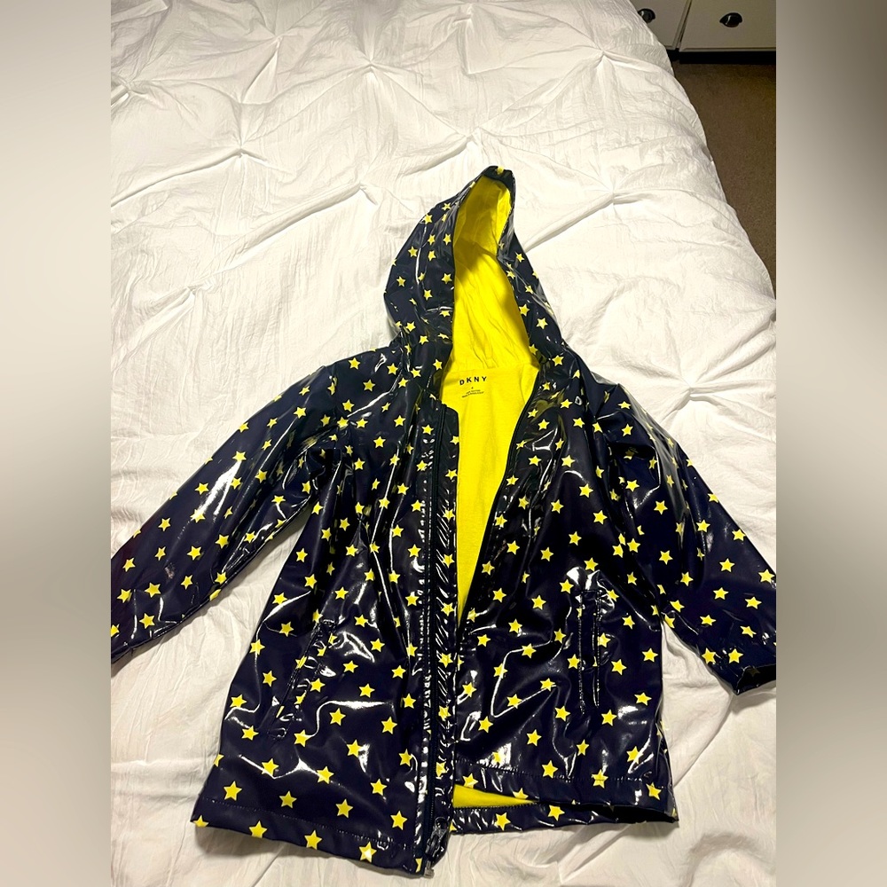 Kids DKNY hooded raincoat. Size 4. Navy blue with yellow stars and bow detail